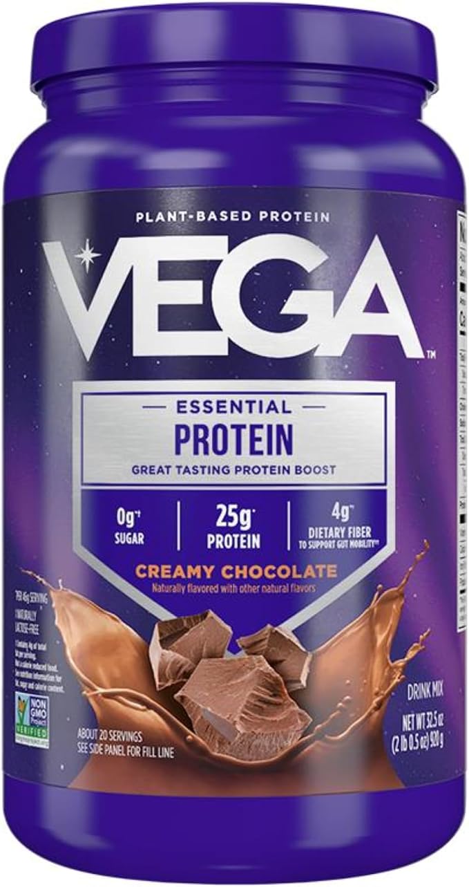 A purple tub of Vega Essential Protein Creamy Chocolate flavor, featuring a chocolate splash graphic on the label.