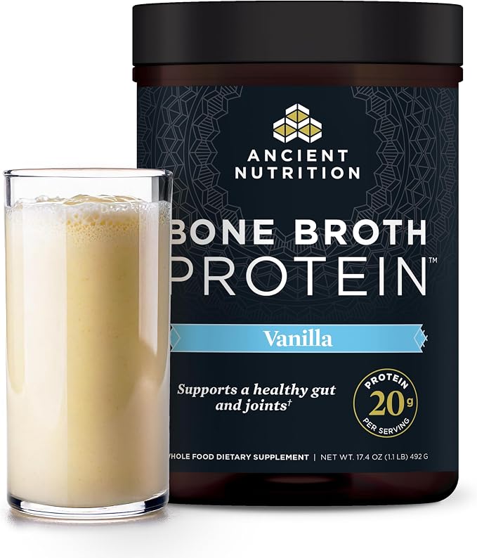 A jar of Ancient Nutrition Bone Broth Protein in Vanilla flavor next to a glass filled with the creamy beige protein powder, on a white background.